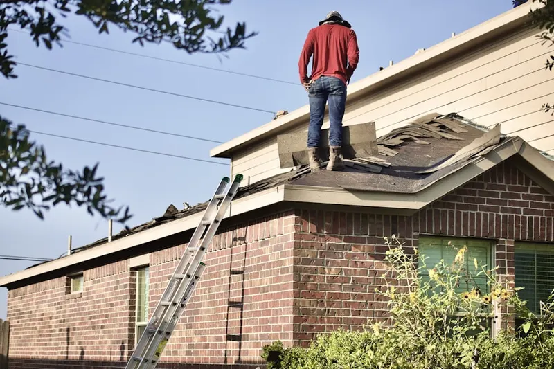 Professional roofer working on a residential roof in Dover Manor